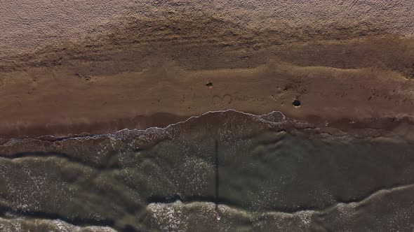 Top View of Texture Waves Sandy Beach Inscription Albania Ionic Sea