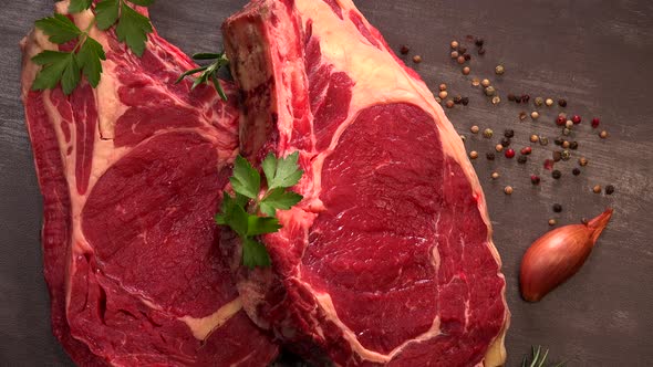 Raw T Bone steak on wooden board prepared to Grill, Entrecote, on turntable, France