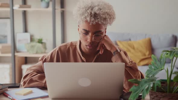 African Lady Using Laptop at Home Frustrated Shocked After Reading Bad News