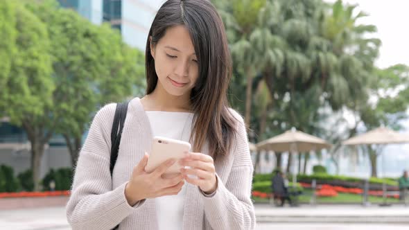 Woman working on mobile phone at outdoor