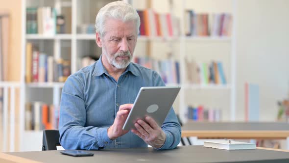 Cheerful Old Man Using Tablet