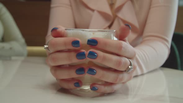 Female Hands Holding Glass Cup of Hot Coffee