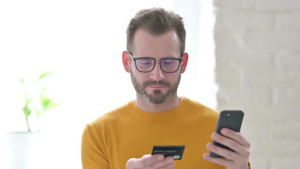 Portrait of Man Unable to Make Online Payment on Smartphone