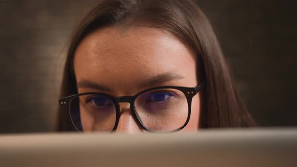 Closeup of Pretty Caucasian Woman Working on Laptop Woman in Eyeglasses Using Laptop Watching