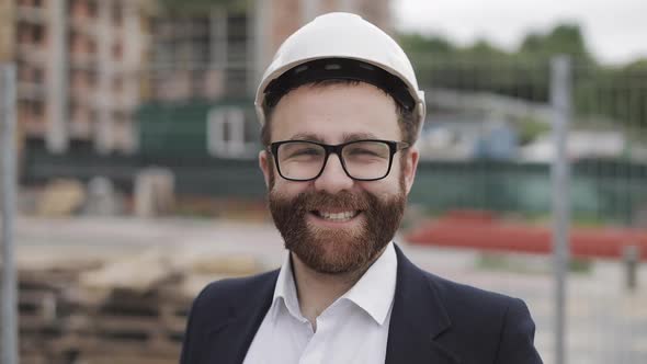 Portrait of Construction Worker on Building Site Smiling at the Camera