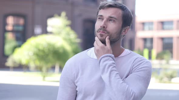 Portrait of Thinking Handsome Man in Office