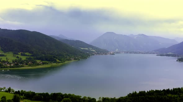The bavarian Tegernsee and its beauty at a cloudy day in summer with the alp mountain panorama. Flyi