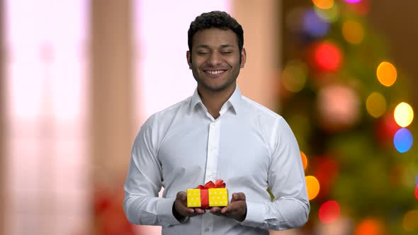 Handsome Businessman Offering Gift Box To Camera.