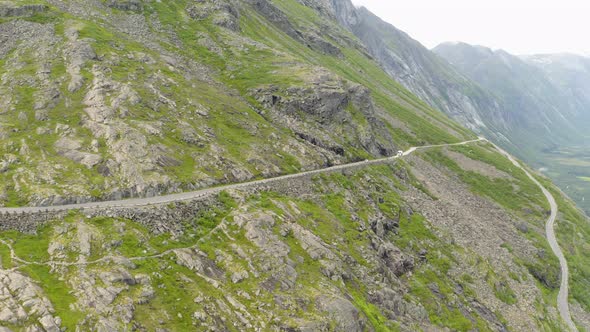 Distant View Of A White Vehicle Traveling On The Trollstigen Mountain Pass In More Og Romsdal, Norwa