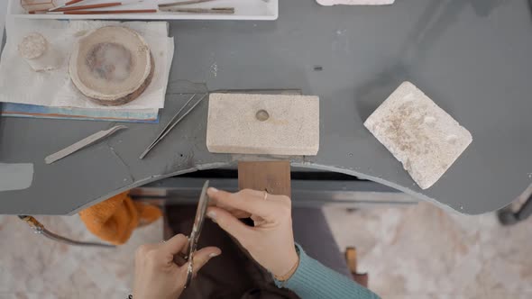 Crop View Of A Jeweler Working On Her Table At The Shop