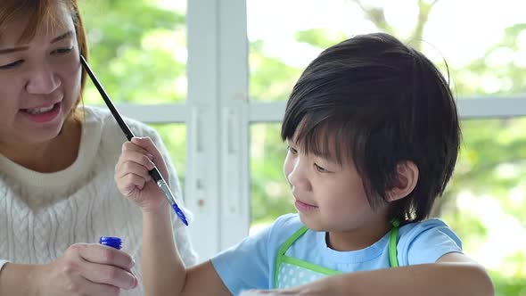 Cute Asian Child And Mother Painting Together