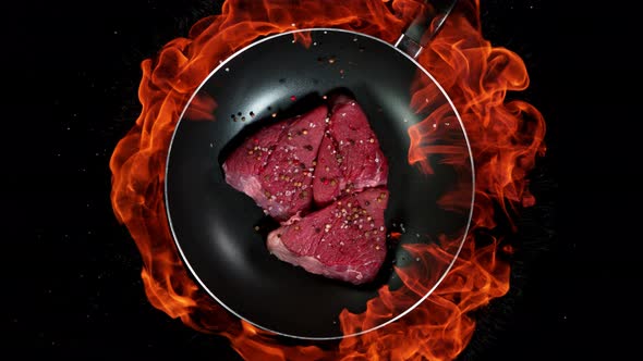 Super Slow Motion Shot of Throwing Beef Meat on Frying Pan and Fire Blast at 1000Fps