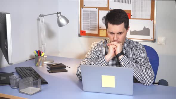 Office Manager Using Laptop. Caucasian Man in Casual Wear Using Laptop.