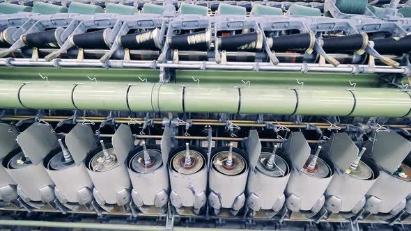 Revolving Spools of a Sewing Machine with Threads on Them