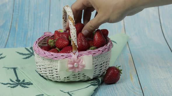 Strawberries in a Small Basket on the Blue Wooden Table - Close Up