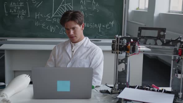 Teacher in His Science Classroom Thinks About 3D Printer