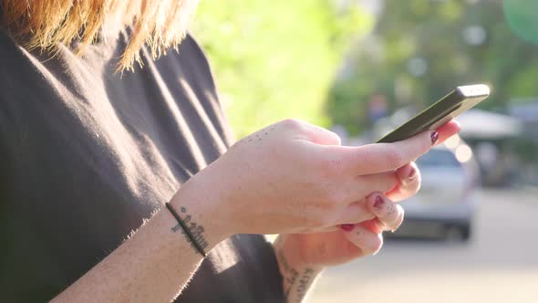 Young woman using smartphone in city