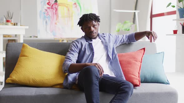 Portrait of african american male artist sitting on the couch at art studio