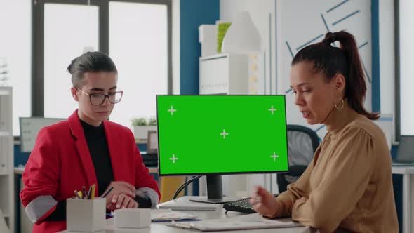 Women Doing Teamwork with Isolated Green Screen on Computer