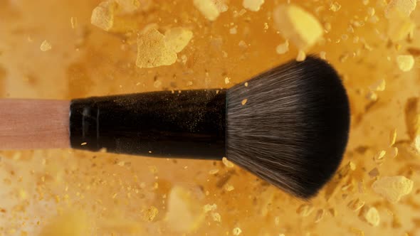 Super Slow Motion Shot of Makeup Brush and Golden Powder Explosion at 1000 Fps
