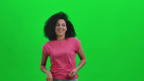 Portrait of Young Female African American Coquettishly Smiling Waving Hand and Showing Gesture Come