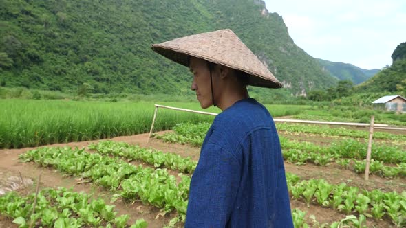 Asian Farmer Walking In His Garden