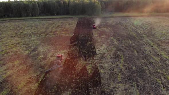 Tractors plow fields before sowing