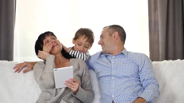 The Child Plays Hide-and-seek, Closing His Mother's Eyes and Saying peek-a-Boo. The Family Spends