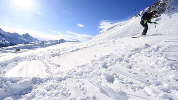 A man skiing on a snow covered mountain