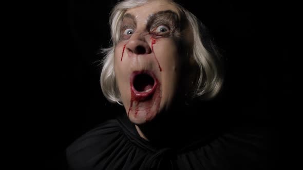 Old Witch Halloween Makeup. Elderly Woman Portrait with Blood on Her Face