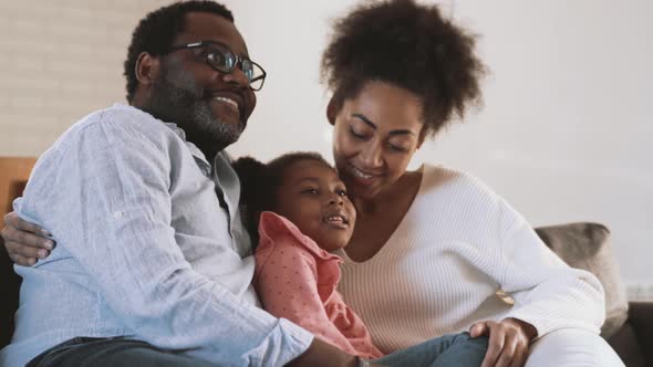 Handsome family watching TV and hugging