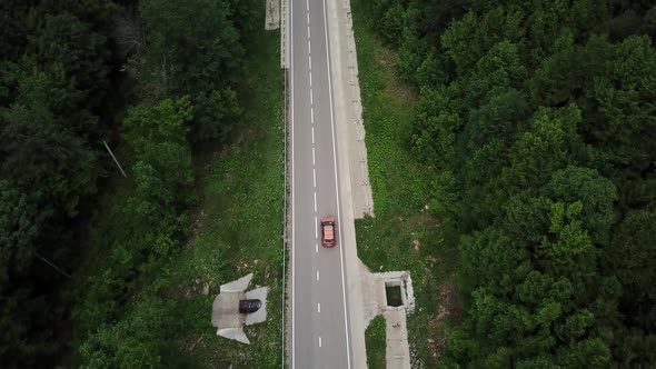 Drone Point of View Tracking Mode Aerial View Flying Over Two Lane Countryside Forest Road with