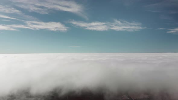 Aerial Shot. Beautiful Flight Above the Clouds Over the Volcanic Valley. In the Frame