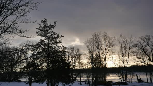 Sunset shrouded by clouds rolling in to go from a partly cloudy evening to overcast