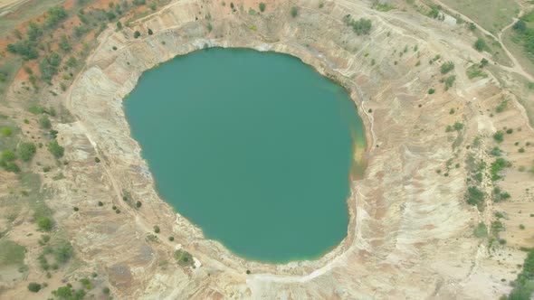 Drone Top View of Abandoned Open-pit Mine Partially Filled with Water in Bulgaria