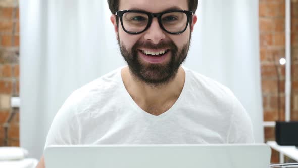 Smiling Positive Beard Man Working on Laptop