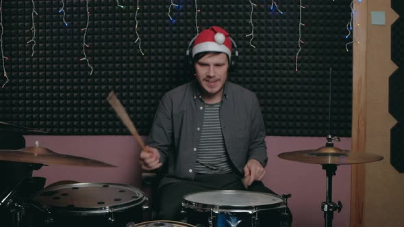 Funny Santa Claus Man Sits Down to Play the Drum Set