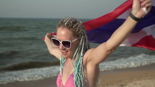 Beautiful Woman with the Flag of Thailand on the Sea Beach Slow Motion