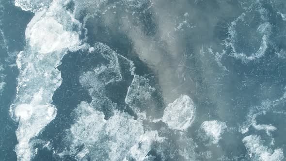 An Aerial View From Above on the Frozen Reservoir. Cracks and Shards of Ice Look Spectacular. Low