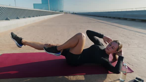 Sportswoman Doing Abs Exercise in Morning