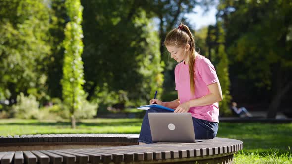 Female Students Using Laptop for Studying in Park