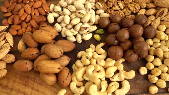 Assorted nuts on a wooden board.