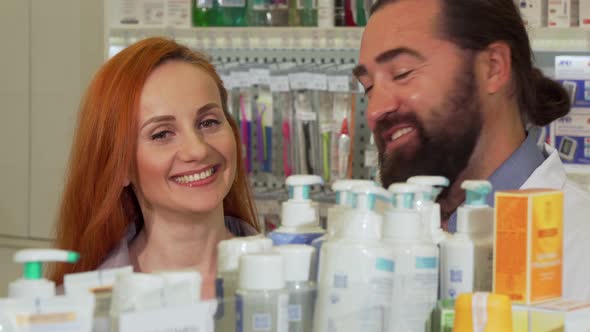 Handsome Bearded Pharmacist Giving His Female Customer Requested Product