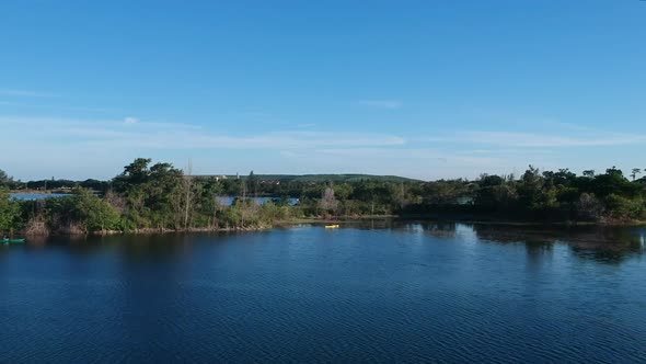 A fasting aerial in a lake swooping by a person kayaking