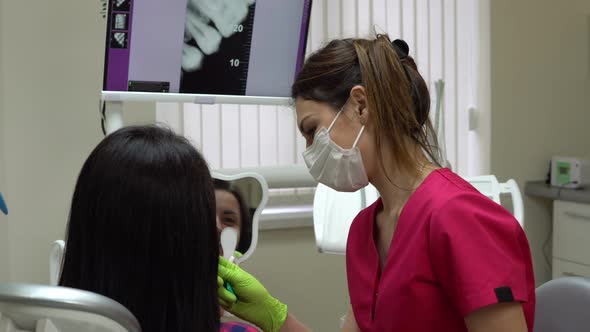 Patient is Looking in the Mirror While Dentist is Explaining Treatment