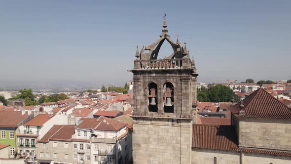 Aerial circling around bell towers on top of Braga Cathedral, Portugal