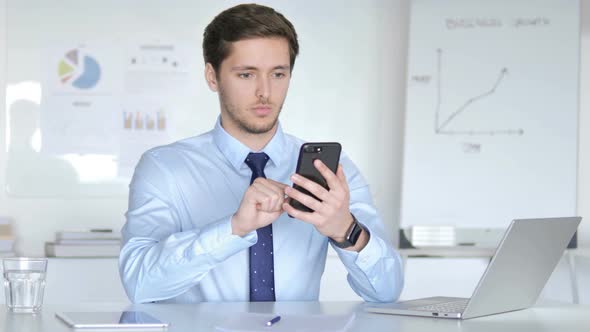 Young Businessman Using Smartphone, Typing Message