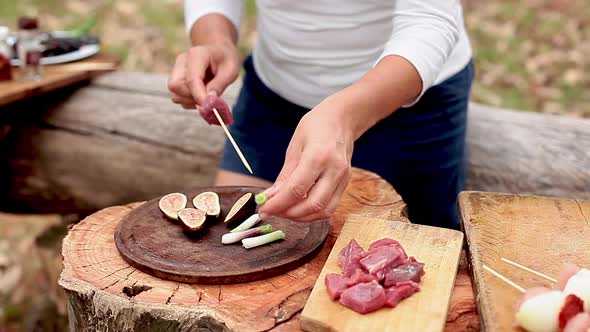 Assembling beef, fig and spring onion kebabs