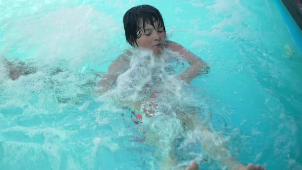 High Angle View Cheerful Wet Cute Kid Lying in Azure Bubbling Water Enjoying Leisure in Swimming