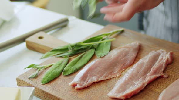 Person preparing sage leaves for saltimbocca